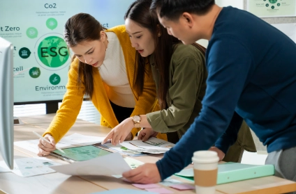 Colleagues reviewing sustainability and ESG reports together.